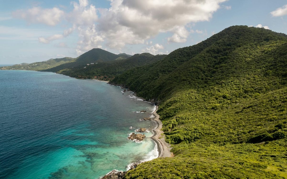 Green hills dropping to turquoise water along the north-west coast road of St. Croix
